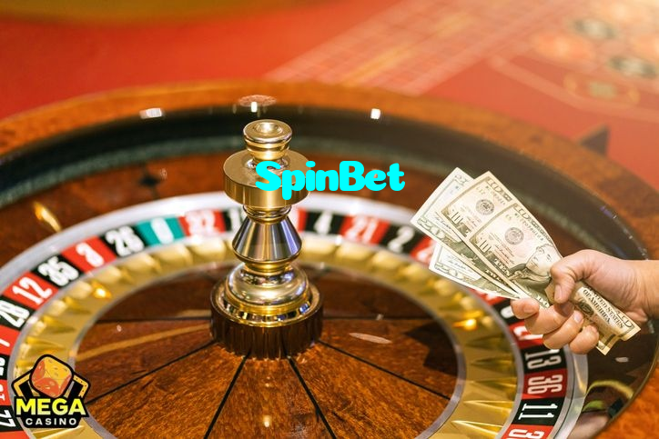 SpinBet casino presented on mobile device in Pakistan with slots and live games
